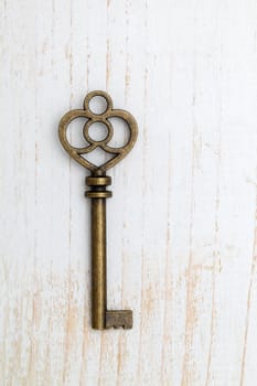 Antique key on white wood background