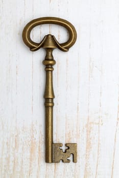 Old key on white wood background