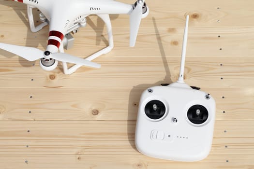 KAGAWA, JAPAN - MARCH 10, 2016: Close-up of drone quadrocopter Dji Phantom 3 Standard Remote Controller. New tool for aerial photo and video. Wooden table background.