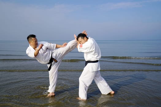 KAGAWA, JAPAN - Jan 3: Japanese karate men training of karate fighting in midwinter of a new year at Ichinomiya Beach, January 3, 2016, Kagawa, Japan