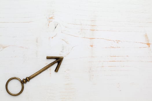 metal arrow on white wood background