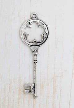 Old key on white wood background