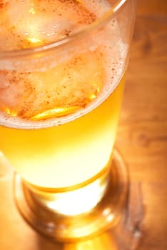 Close-up of a beer glass with foam on the table
