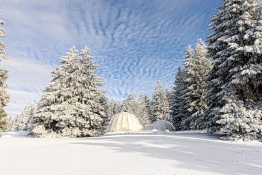 the winter landscape with white huts