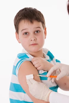 Doctor giving a child injection in arm on isolated image.