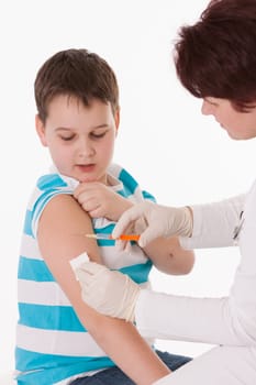 Doctor giving a child injection in arm on isolated image.