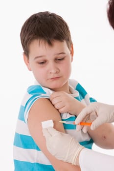Doctor giving a child injection in arm on isolated image.