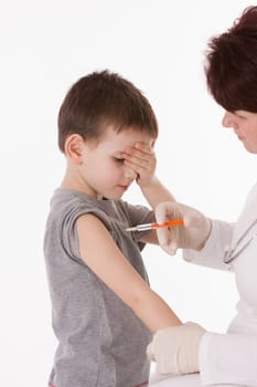 Doctor giving a child injection in arm on isolated image.