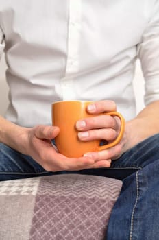Man on a sofa with a pot of coffee