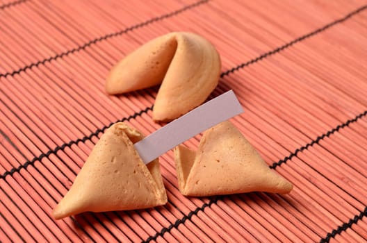 Fortune cookies on a red bamboo mat