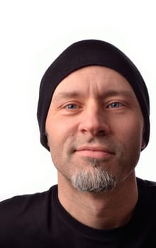 Grinning man wearing a black beanie on a white background