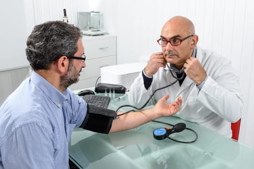 Doctor and patient with blood pressure meter in Doctor's office.