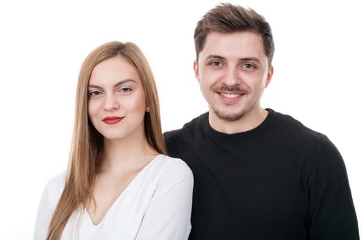 Young couple standing close to each other in studio