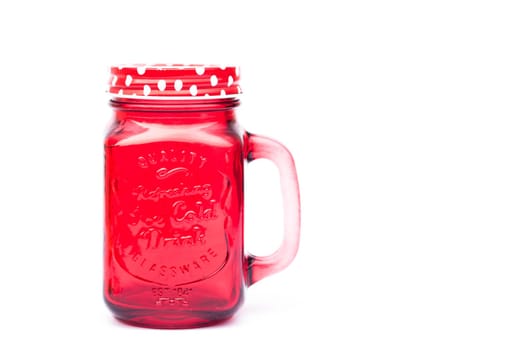 Red mason glass on white background, stock photo