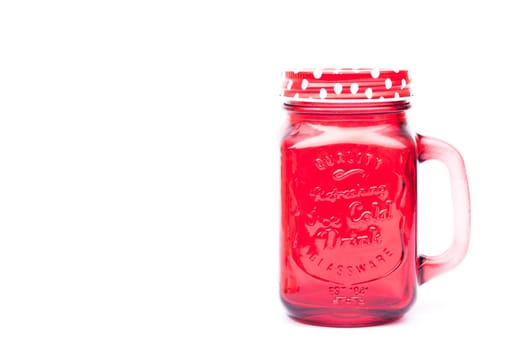 Red mason glass on white background, stock photo