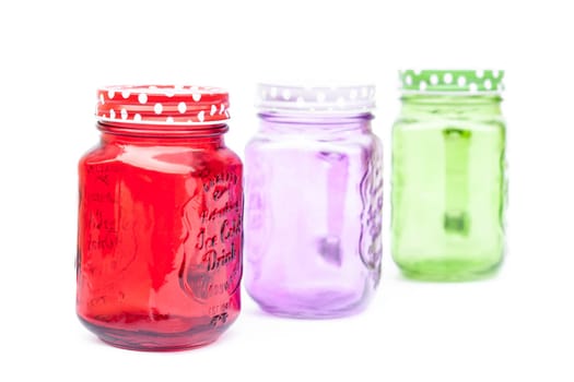 Colourful mason glasses on white background, stock photo