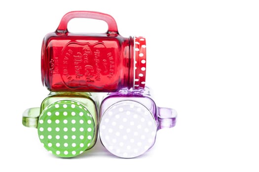 Colourful mason glasses on white background, stock photo