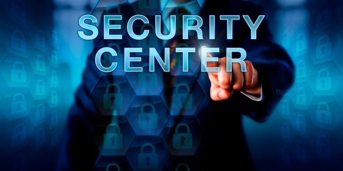 Cyber professional is pressing SECURITY CENTER on a touch screen interface. Business metaphor and security technology concept. Locked lock icons embedded in hexagonal structures represent firewalls.