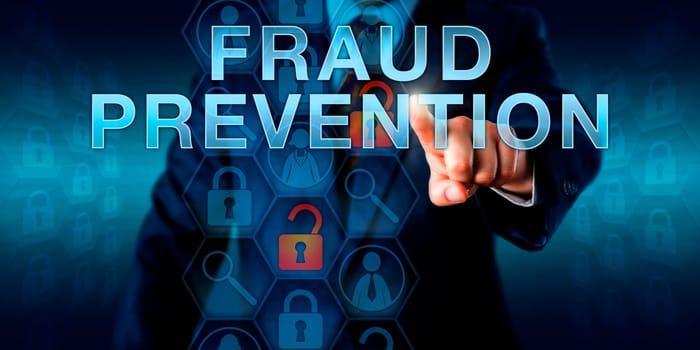 Forensic examiner is pushing FRAUD PREVENTION on a virtual screen. Business services metaphor and law enforcement concept for countermeasures to internet fraud, identity theft and computer crime.
