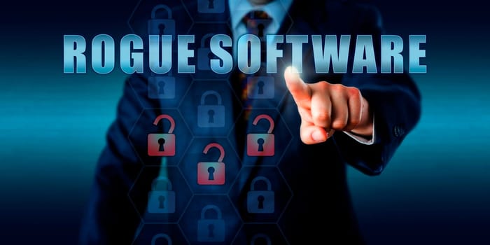 Misled corporate computer user pressing ROGUE SOFTWARE on a touch screen. Information security concept for malicious programs and fraudulent internet activity that con users into paying ransom money.