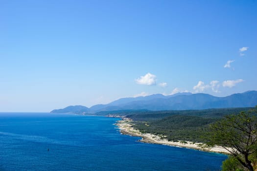 Overlooking the crystal clear sea with the meandering coastline and the tropical landscape
