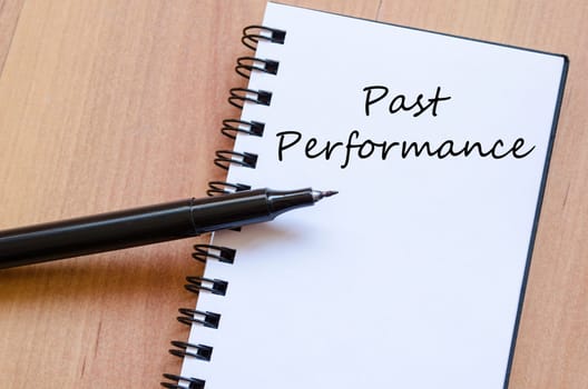Past performance text concept write on notebook with pen