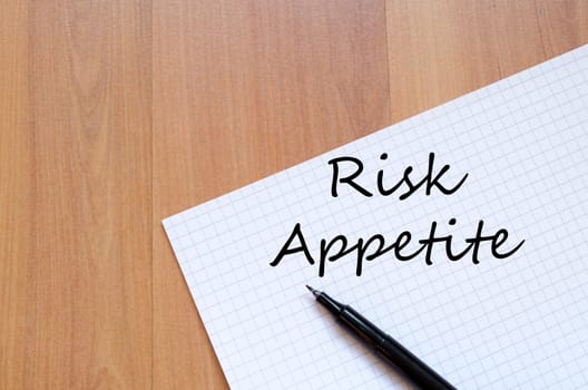 Risk appetite text concept write on notebook with pen