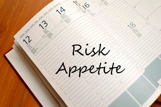 Risk appetite text concept write on notebook with pen
