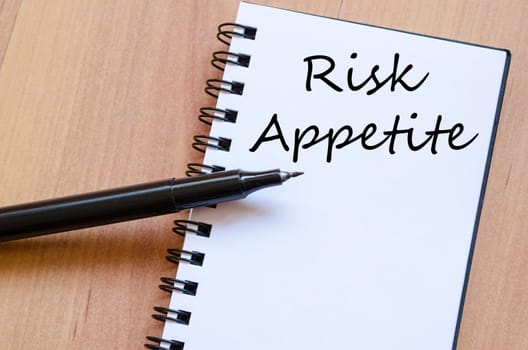 Risk appetite text concept write on notebook with pen