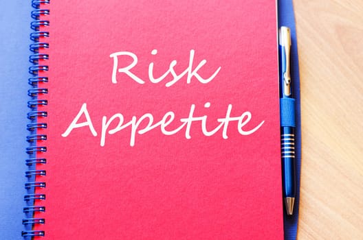 Risk appetite text concept write on notebook with pen