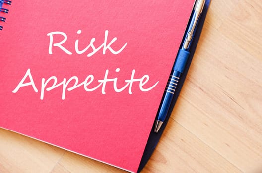 Risk appetite text concept write on notebook with pen