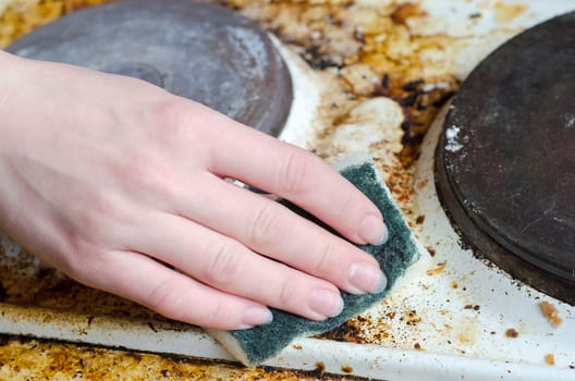 Women hand clean dirty stove
