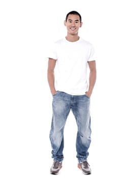 Smiling young man standing over white background