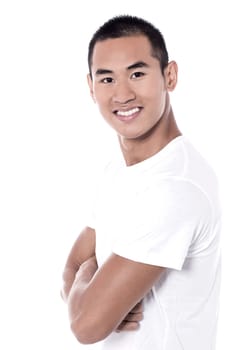 Casual young man looking at camera with crossed arms