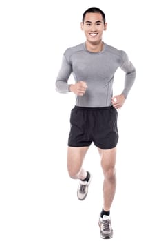Fit handsome muscular young man jogging