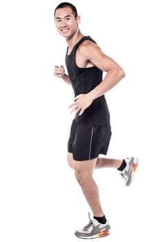 Young man jogging actively with ear phones
