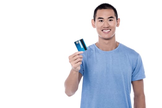 Happy young man displaying his cash card