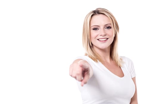 Pretty woman pointing index finger towards camera