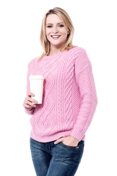 Pretty young woman posing with disposable cup