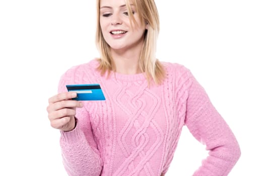 Woman in knitwear looking her debit card