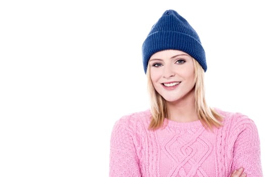 Portrait of young woman with knitwear and cap