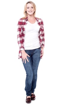 Fashionable young woman standing against white background