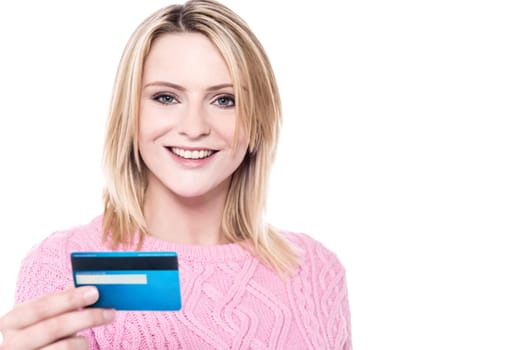 Pretty woman with knitted wear showing debit card