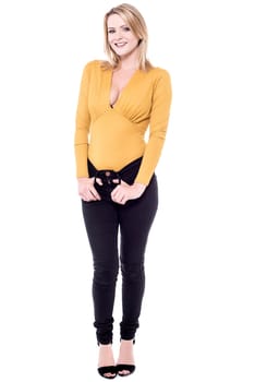Trendy young woman standing on white background
