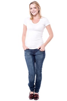 Full length image of young woman with hands in pockets