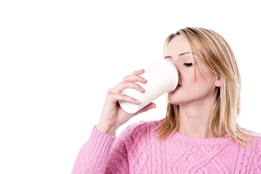 Woman sipping the take-away cup over white
