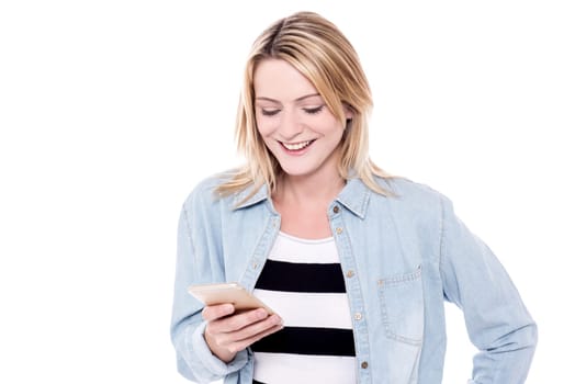 Pretty young girl looking into her mobile phone