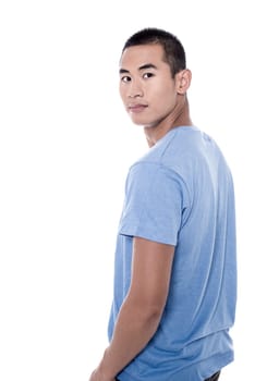 Casual young man looking over his shoulder