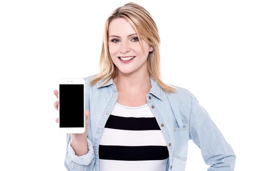Fashionable young woman displaying smart phone to camera
