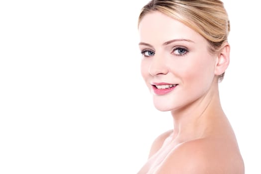 Young woman with bare shoulders posing to camera
